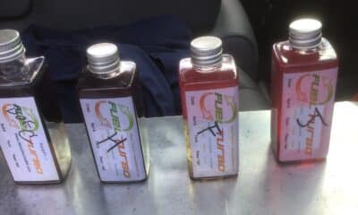 Fuel Polishing Can Help Eliminate Build Up In Your Fuel. The Two Bottles On The Left Have Dark, Contaminated Fuel. The Two Bottles On The Right Have Bright, Red Clean Fuel.