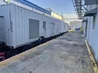 Extensive MegaWattage Trailer Sitting At loading Dock With Caterpillar Industrial Generator Inside.