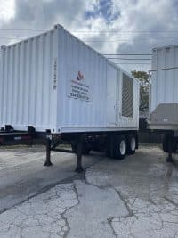 Massive MegaWattage Trailer Holding Large Commercial Generators For Transportation.