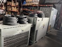 Three Diesel Generators With Cables Stacked On Top Of Them.