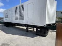 Massive MegaWattage Trailer Holding Large Commercial Generators For Transportation.
