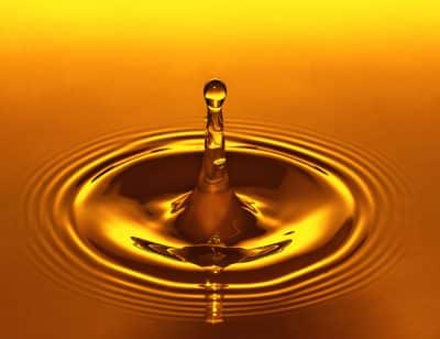 A drop of amber colored oil caused a ripple effect.
