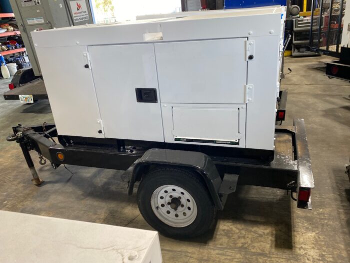 External View Of A Trailer-Mounted 20kW MultiQuip WhisperWatt Generator.